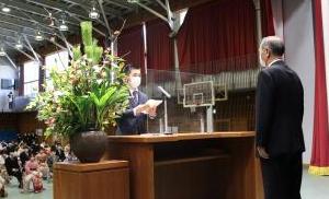 演台をはさみ向かい合わせに立っている町長と式辞表を持ち誓いのことばを述べているスーツ姿の男性の写真