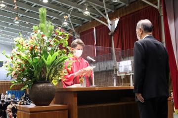 演台をはさみ向かい合わせに立っている町長と式辞表を持ち誓いのことばを述べている羽織袴姿の男性の写真