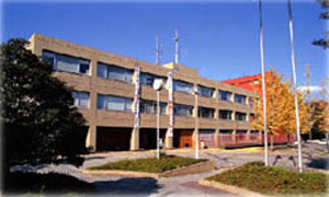 外観が茶色3階建ての小川町役場の写真